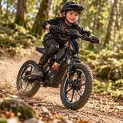 Child riding a black Kayo eKB-M16 on a dusty trail — source: Kyro Bikes